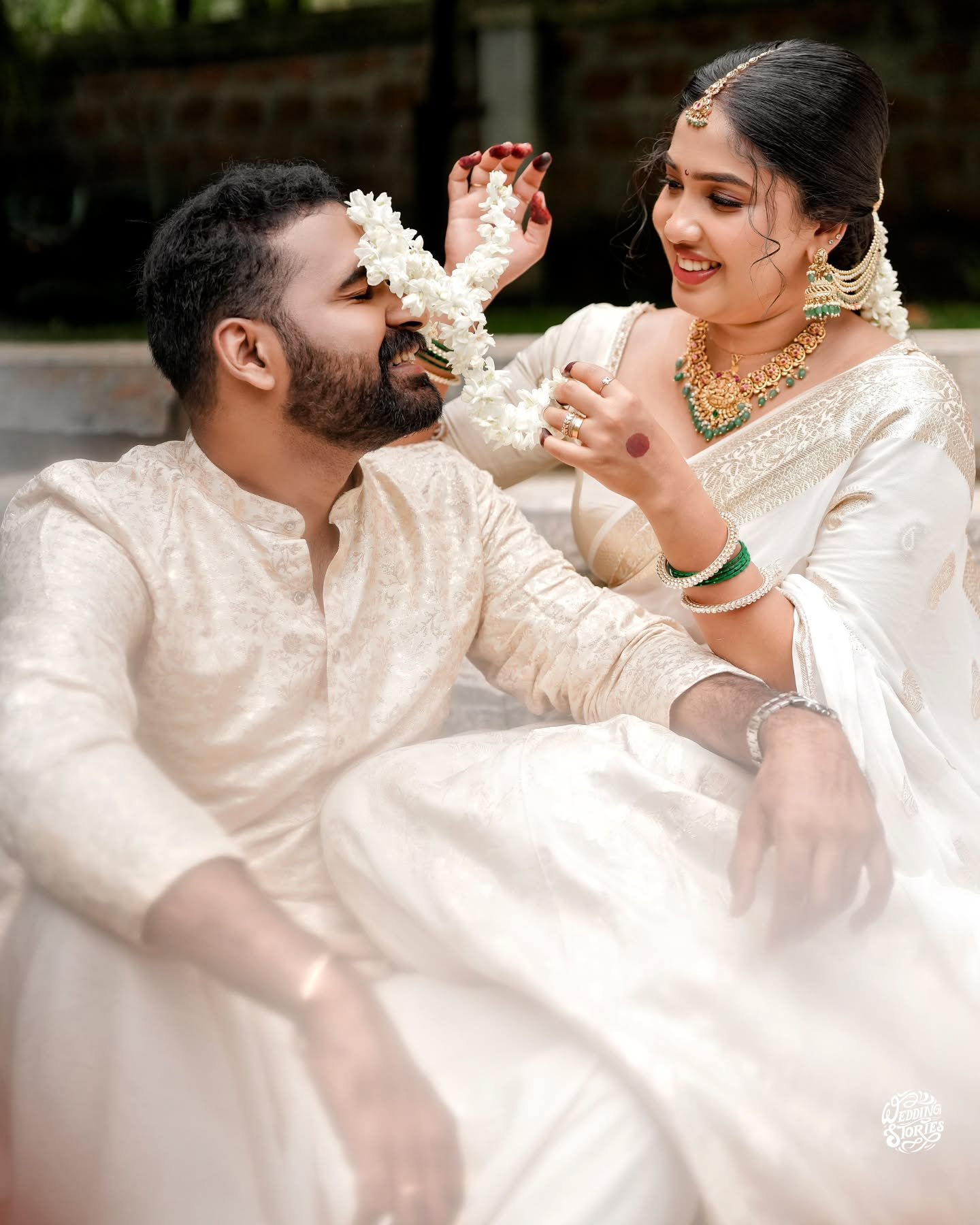 A newlywed couple sharing a playful moment during their ceremony